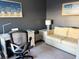 Bright home office features a desk, comfortable sofa, and ample natural light at 1274 Burgos Dr # 1101, Sarasota, FL 34238