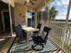 Screened balcony with lake view, table, and chairs at 1274 Burgos Dr # 1101, Sarasota, FL 34238