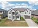 Two-story house with gray siding, brown garage door, and landscaping at 12985 Bliss Loop, Bradenton, FL 34211