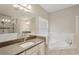 Bathroom with soaking tub and double vanity at 12985 Bliss Loop, Bradenton, FL 34211