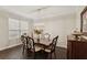 Formal dining room with dark hardwood floors, chandelier, and sideboard at 12985 Bliss Loop, Bradenton, FL 34211