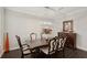 Elegant dining room features a dark wood table with six chairs and a statement light fixture at 12985 Bliss Loop, Bradenton, FL 34211