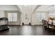 Bright entryway with dark hardwood floors, and a view of the dining room at 12985 Bliss Loop, Bradenton, FL 34211