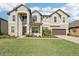 Two-story house with gray siding, brown garage door, and landscaping at 12985 Bliss Loop, Bradenton, FL 34211