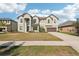 Two-story house with gray siding, brown garage door, and landscaping at 12985 Bliss Loop, Bradenton, FL 34211