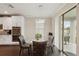 Breakfast nook with a round glass table and four leather chairs at 12985 Bliss Loop, Bradenton, FL 34211