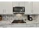 Kitchen detail showing cooktop, microwave, and coffee maker at 12985 Bliss Loop, Bradenton, FL 34211