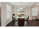 Breakfast nook with a round glass table and four leather chairs at 12985 Bliss Loop, Bradenton, FL 34211