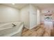 Relaxing bathroom with a large bathtub and wood-look floors at 1313 Harbor Blvd, Port Charlotte, FL 33952