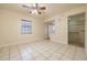 Spacious bedroom with tiled floors and ceiling fan at 1313 Harbor Blvd, Port Charlotte, FL 33952