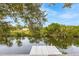 Serene canal-front property showcasing a private dock and lush greenery at 1313 Harbor Blvd, Port Charlotte, FL 33952