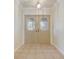 Bright entryway with tiled floor and double doors at 1313 Harbor Blvd, Port Charlotte, FL 33952