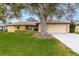 Single-story home with attached garage and lush lawn at 1313 Harbor Blvd, Port Charlotte, FL 33952