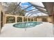 Inviting kidney-shaped pool with a screened enclosure and a tranquil setting at 1313 Harbor Blvd, Port Charlotte, FL 33952