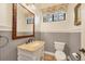 Small bathroom with pedestal sink, toilet and decorative mirror at 135 N Creek Ln, Osprey, FL 34229