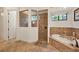 Spa-like bathroom with walk-in shower, soaking tub, and tiled walls at 135 N Creek Ln, Osprey, FL 34229