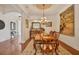 Bright dining room featuring a chandelier and hardwood floors at 135 N Creek Ln, Osprey, FL 34229