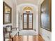 Elegant entryway with hardwood floors, double glass doors, and ornate mirror at 135 N Creek Ln, Osprey, FL 34229