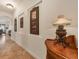 Bright hallway with decorative wall art and wood accent table at 135 N Creek Ln, Osprey, FL 34229