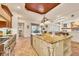 Open kitchen with an island, granite countertops and breakfast nook at 135 N Creek Ln, Osprey, FL 34229