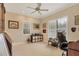 Home office with built-in shelving, large windows, and comfortable chair at 135 N Creek Ln, Osprey, FL 34229