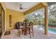 Screened pool patio with table and chairs near the grill at 135 N Creek Ln, Osprey, FL 34229