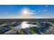 Aerial view of home on a lake with neighborhood in background at 15009 18Th E Run, Parrish, FL 34219