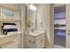 White bathroom with a vanity, shelves, and a pool view at 15009 18Th E Run, Parrish, FL 34219