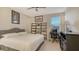 Bedroom with desk, dresser and large bed at 15009 18Th E Run, Parrish, FL 34219