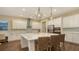 Modern kitchen featuring a large island and white cabinets at 15009 18Th E Run, Parrish, FL 34219