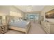 Peaceful main bedroom with a king-size bed and water view at 15009 18Th E Run, Parrish, FL 34219