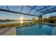 Inviting pool with a screened enclosure and lake view at 15009 18Th E Run, Parrish, FL 34219