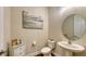 Elegant powder room with white pedestal sink and oval mirror at 15009 18Th E Run, Parrish, FL 34219