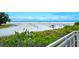 Scenic overlook of a beautiful beach with people enjoying the sand at 1604 Stickney Point Rd # 102, Sarasota, FL 34231