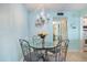 Small dining area with glass-top table and four ornate chairs at 1604 Stickney Point Rd # 102, Sarasota, FL 34231