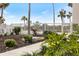 Landscaped walkway to inviting pool area with tropical plants at 1604 Stickney Point Rd # 102, Sarasota, FL 34231