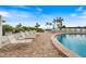 Relaxing pool area with lounge chairs and waterfront views at 1604 Stickney Point Rd # 102, Sarasota, FL 34231