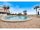 Inviting circular pool surrounded by lounge chairs and lush landscaping at 1604 Stickney Point Rd # 102, Sarasota, FL 34231