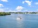 Peaceful waterway with boat and luxurious homes in the background at 1604 Stickney Point Rd # 102, Sarasota, FL 34231