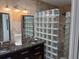 Elegant bathroom with glass block shower and dark granite vanity at 1666 Pintail Way # 9, Sarasota, FL 34231