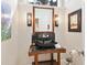 Elegant powder room featuring a unique stone sink, custom lighting, and a decorative mirror at 1666 Pintail Way # 9, Sarasota, FL 34231