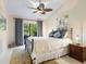 Bedroom featuring a decorative fan, soft lighting, and backyard views at 1666 Pintail Way # 9, Sarasota, FL 34231