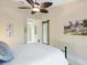 Bright bedroom featuring a ceiling fan, stylish mirror, and natural light at 1666 Pintail Way # 9, Sarasota, FL 34231