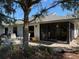 Home's exterior showcasing a patio area with seating and access to the backyard at 1666 Pintail Way # 9, Sarasota, FL 34231