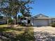 Single story home with white exterior, gray roof, and landscaped yard at 1666 Pintail Way # 9, Sarasota, FL 34231