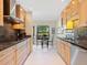 Open concept kitchen looking towards the breakfast nook area with wooden cabinetry and white flooring at 1666 Pintail Way # 9, Sarasota, FL 34231