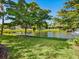 Picturesque pond surrounded by mature trees and lush greenery, creating a serene and peaceful atmosphere at 1666 Pintail Way # 9, Sarasota, FL 34231