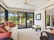 Bright sunroom with lots of light features a ceiling fan and comfortable seating with serene outdoor views at 1666 Pintail Way # 9, Sarasota, FL 34231