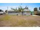 Large backyard with a tree and grassy area at 1956 Massachusetts Ave, Englewood, FL 34224