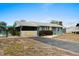 Cute beach cottage with yellow chairs and a life preserver on the wall at 1956 Massachusetts Ave, Englewood, FL 34224